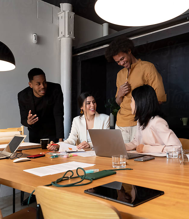 Group of Business People Gathered Around a Table Having a Meeting